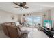 Living room with palm ceiling fan and ocean view at 880 Mandalay Ave # C513, Clearwater Beach, FL 33767