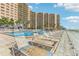 Relax by the pool with lounge chairs at this beachfront condo at 880 Mandalay Ave # C513, Clearwater Beach, FL 33767