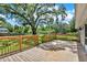 Wooden deck featuring a fenced-in backyard with a large, mature tree offering shade at 9448 Mcintyre Rd, Brooksville, FL 34601