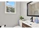 Bathroom featuring updated vanity, modern fixtures, and a window for natural light at 9448 Mcintyre Rd, Brooksville, FL 34601