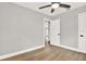 Bedroom with hardwood floors, ceiling fan, and white doors, creating a clean and modern look at 9448 Mcintyre Rd, Brooksville, FL 34601