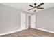 Bedroom with hardwood floors, ceiling fan, and white doors, creating a clean and modern look at 9448 Mcintyre Rd, Brooksville, FL 34601