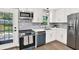 Modern kitchen with stainless steel appliances, updated cabinets, and backyard access at 9448 Mcintyre Rd, Brooksville, FL 34601
