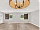 Spacious living room with wood floors and decorative lighting fixtures with barn door shutters at 9448 Mcintyre Rd, Brooksville, FL 34601