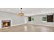 Bright living room featuring wood floors, a fireplace, and stylish barn door shutters at 9448 Mcintyre Rd, Brooksville, FL 34601