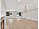 Large living room with wood floors, fireplace, and barn door shutters for a modern look at 9448 Mcintyre Rd, Brooksville, FL 34601