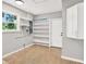 Utility room with window, shelving, and tile floors for a functional space at 9448 Mcintyre Rd, Brooksville, FL 34601