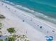 An aerial shot showcases the beach, ocean, and nearby condos along the scenic coastline at 960 Gulf Blvd # 5, Indian Rocks Beach, FL 33785
