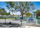 Fully-fenced dog park with shade, agility equipment, and waste disposal at 960 Gulf Blvd # 5, Indian Rocks Beach, FL 33785
