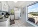 Bright kitchen features tile floors, white cabinets, and a view of the beach from the window at 960 Gulf Blvd # 5, Indian Rocks Beach, FL 33785