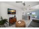 Open-concept living room with a TV, a wicker ottoman, and a view of the kitchen at 960 Gulf Blvd # 5, Indian Rocks Beach, FL 33785