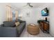Comfortable living room featuring a gray sofa, a TV, and a unique coffee table at 960 Gulf Blvd # 5, Indian Rocks Beach, FL 33785