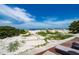 Expansive view of the sandy beach from the deck of the beachside cottage at 960 Gulf Blvd # 5, Indian Rocks Beach, FL 33785