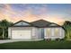 Charming single-story home with a two-car garage, complemented by lush landscaping at 9726 Redwood Heights Loop, Thonotosassa, FL 33592