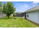 Backyard with green lawn, fire pit, and screened-in pool area at 10457 Cranston St, Spring Hill, FL 34608