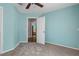 Carpeted bedroom featuring a ceiling fan, and a doorway leading to another room at 10457 Cranston St, Spring Hill, FL 34608