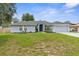 Beautiful single story home with a well manicured lawn and mature landscaping on an overcast day at 10457 Cranston St, Spring Hill, FL 34608