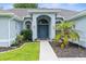 Charming home featuring a beautiful arched entryway, well-maintained landscaping, and a welcoming front door at 10457 Cranston St, Spring Hill, FL 34608