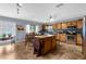 Spacious eat in kitchen with a tile backsplash, stainless steel appliances, and a center island at 10457 Cranston St, Spring Hill, FL 34608