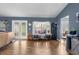 Living room with lots of light, wood floors, with a view to the kitchen at 10457 Cranston St, Spring Hill, FL 34608
