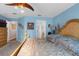 Large main bedroom featuring blue walls, neutral carpeting and a ceiling fan at 10457 Cranston St, Spring Hill, FL 34608