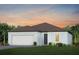 Charming single-story home featuring a two-car garage, lush landscaping, and a well-manicured lawn at 11439 Shoreline Trl, Parrish, FL 34219
