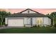 Charming single-story home features a neutral color palette, attached garage, and well-maintained landscaping at 11444 Shoreline Trl, Parrish, FL 34219