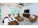 Cozy living room featuring a decorative wall, comfortable seating, and large windows offering scenic views at 11444 Shoreline Trl, Parrish, FL 34219