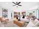 Bright and inviting living room featuring stylish furnishings and an open floor plan, seamlessly connecting to the kitchen at 11444 Shoreline Trl, Parrish, FL 34219