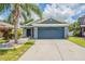 Charming one-story home with a well-manicured lawn and a two-car garage at 11448 Bay Gardens Loop, Riverview, FL 33569