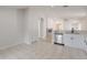 Clean and bright kitchen with white cabinetry, stainless appliances, and open floor plan at 11448 Bay Gardens Loop, Riverview, FL 33569