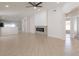 Bright, open-concept living room with tile flooring and a stylish fireplace at 11448 Bay Gardens Loop, Riverview, FL 33569