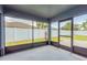 Screened-in porch overlooking the backyard, featuring an exit to the yard at 11448 Bay Gardens Loop, Riverview, FL 33569
