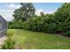 Lush backyard with mature landscaping, offering privacy and a serene outdoor space at 1156 Ridgegrove W Dr, Palm Harbor, FL 34683