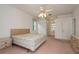 Large primary bedroom with carpet, natural light, and plenty of room for furnishings at 1156 Ridgegrove W Dr, Palm Harbor, FL 34683