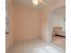 Neutral secondary bedroom with tile floors and doorway to primary bedroom at 1156 Ridgegrove W Dr, Palm Harbor, FL 34683