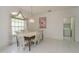Dining room with tiled flooring, a hanging light fixture, and a window with curtains at 1156 Ridgegrove W Dr, Palm Harbor, FL 34683