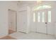 Bright foyer with tiled flooring, a front door with sidelights, and a coat closet at 1156 Ridgegrove W Dr, Palm Harbor, FL 34683