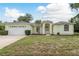 Inviting single-story home features a manicured lawn and attached two-car garage at 1156 Ridgegrove W Dr, Palm Harbor, FL 34683