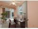 Bright office space with a dark desk, leading out to the screened patio and pool at 1156 Ridgegrove W Dr, Palm Harbor, FL 34683