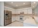 The bright, white kitchen features stainless steel appliances and ample cabinet space at 1156 Ridgegrove W Dr, Palm Harbor, FL 34683