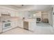 Well-lit kitchen with stainless steel dishwasher open to the living room and backyard views at 1156 Ridgegrove W Dr, Palm Harbor, FL 34683