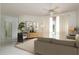 Bright living room featuring neutral tones, stylish furnishings, and a large window with natural light at 1156 Ridgegrove W Dr, Palm Harbor, FL 34683