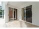 Covered patio with tile flooring and sliding glass doors, providing seamless indoor-outdoor living at 1156 Ridgegrove W Dr, Palm Harbor, FL 34683