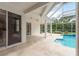 Spacious covered patio adjacent to a sparkling pool, ideal for entertaining and relaxation at 1156 Ridgegrove W Dr, Palm Harbor, FL 34683