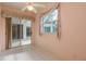 Bright sunroom with tile floors, fan and sliding doors leading to a screened-in lanai at 1156 Ridgegrove W Dr, Palm Harbor, FL 34683
