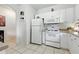 Bright kitchen with white cabinets, modern appliances, and tile flooring at 1201 High Hammock Dr # 302, Tampa, FL 33619