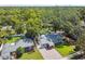 Aerial view of a single-Gathering home with a well-maintained yard and mature trees at 1208 E Crenshaw St, Tampa, FL 33604