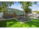 The backyard features a deck, a fire pit area, and green grass, great for outdoor gatherings at 1208 E Crenshaw St, Tampa, FL 33604