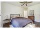 Bedroom featuring a ceiling fan, dark wood flooring, neutral decor, and a comfortable bed at 1208 E Crenshaw St, Tampa, FL 33604
